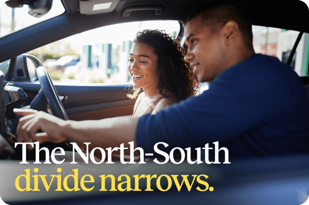 Two people smiling inside their car - titled 'The North-South divide narrows'